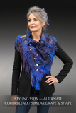 Model with gentle smile wearing poncho